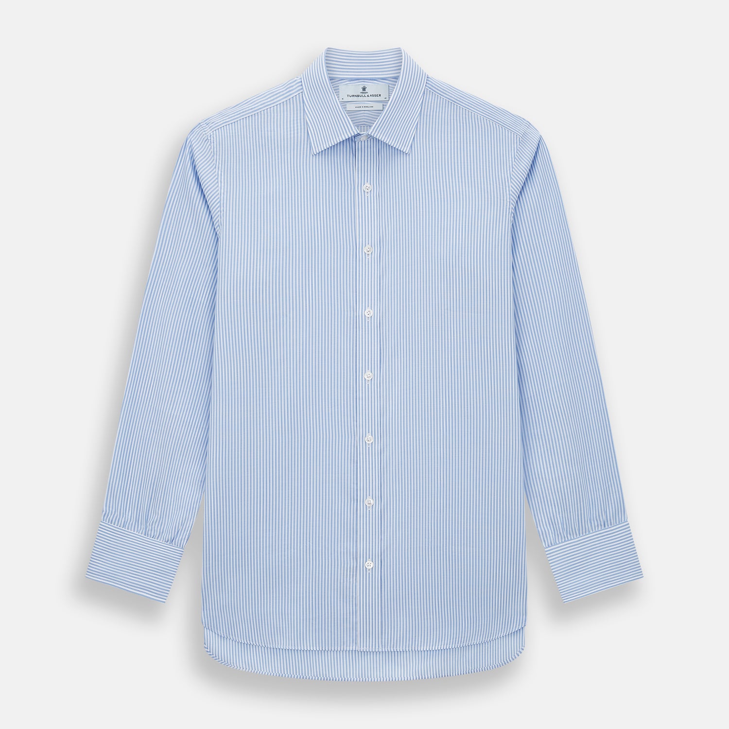 View 1 of product The Turnbull & Asser Blue Bengal Stripe Mayfair Shirt features light blue and white vertical stripes, a classic T&A collar, white buttons, and buttoned cuffs. Laid flat on a white background.