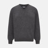 View 1 of product The Charcoal Grey Cashmere V-neck Jumper by Turnbull & Asser features ribbed cuffs, hem, and neckline—an essential knitwear piece, shown on a white background.
