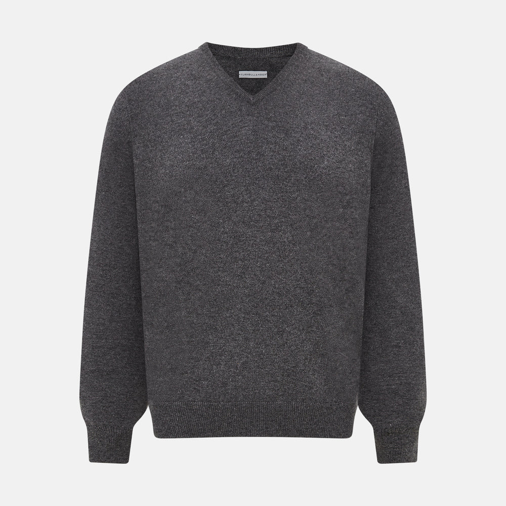 The Charcoal Grey Cashmere V-neck Jumper by Turnbull & Asser features ribbed cuffs, hem, and neckline—an essential knitwear piece, shown on a white background.