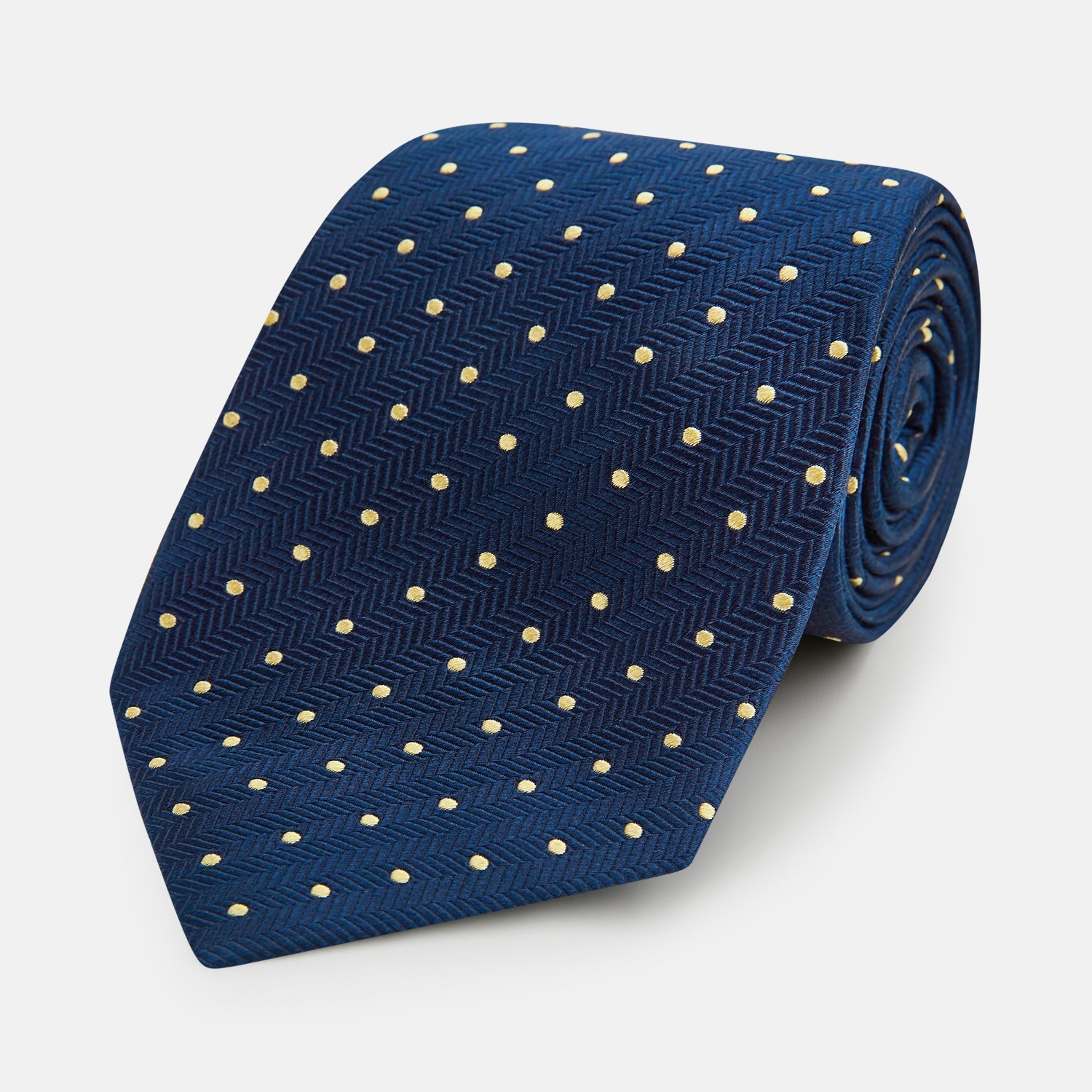 View 1 of product The Turnbull & Asser Navy and Gold Micro Dot Silk Tie showcases subtle herringbone texture with gold micro dots, offering a refined and modern look for the office.