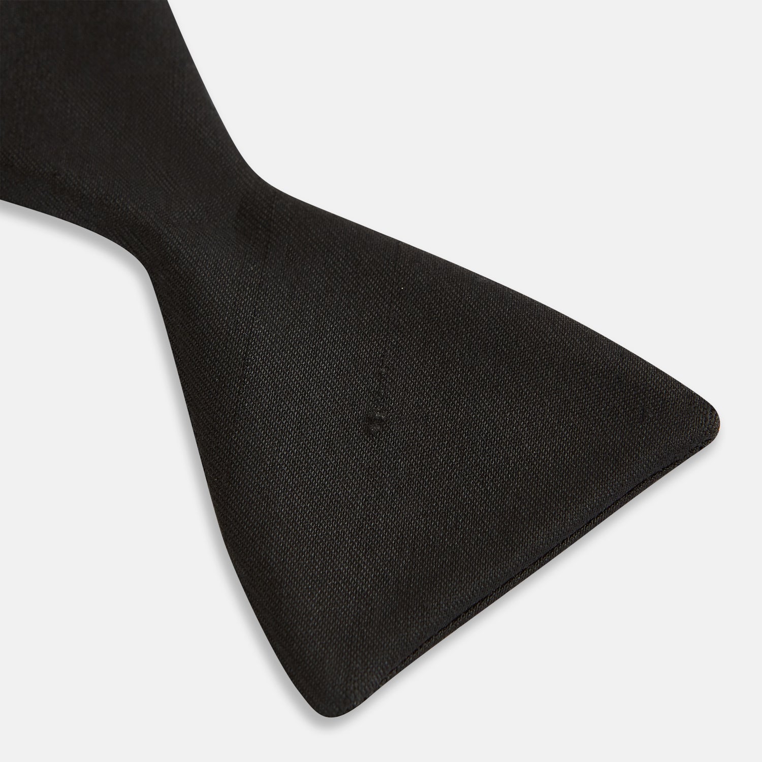 Image 6 of product The Casino Royale Bow Tie by Turnbull & Asser, as seen on James Bond, is a classic black Shantung silk bow tie with a smooth, slightly shiny finish, shown against a plain white background.