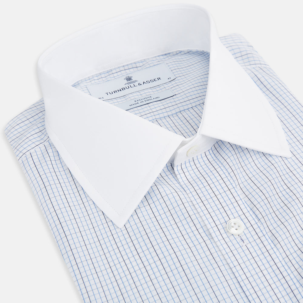 The Turnbull & Asser Pale Blue and Navy Grid Check Shirt features a contrast T&A collar and cuffs, long sleeves, and a button-down front, all displayed on a plain white background.