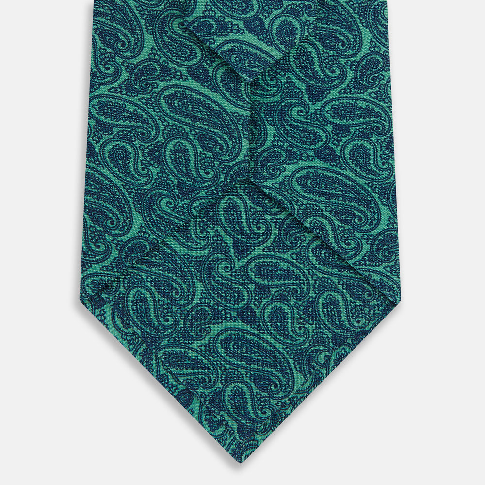 The Kelly Green Paisley Printed Silk Tie by Turnbull & Asser features an elegant paisley pattern and is expertly crafted from luxurious English silk.