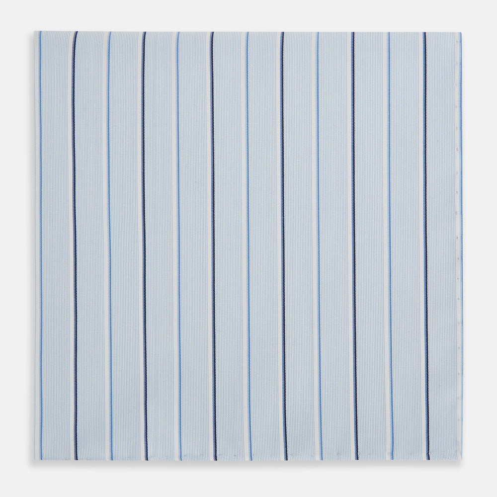 The Turnbull & Asser Navy and Blue Combination Stripe Hand-Rolled Handkerchief features a light blue base with evenly spaced dark blue pinstripes and refined hand-rolled edges, offering a classic, elegant look.