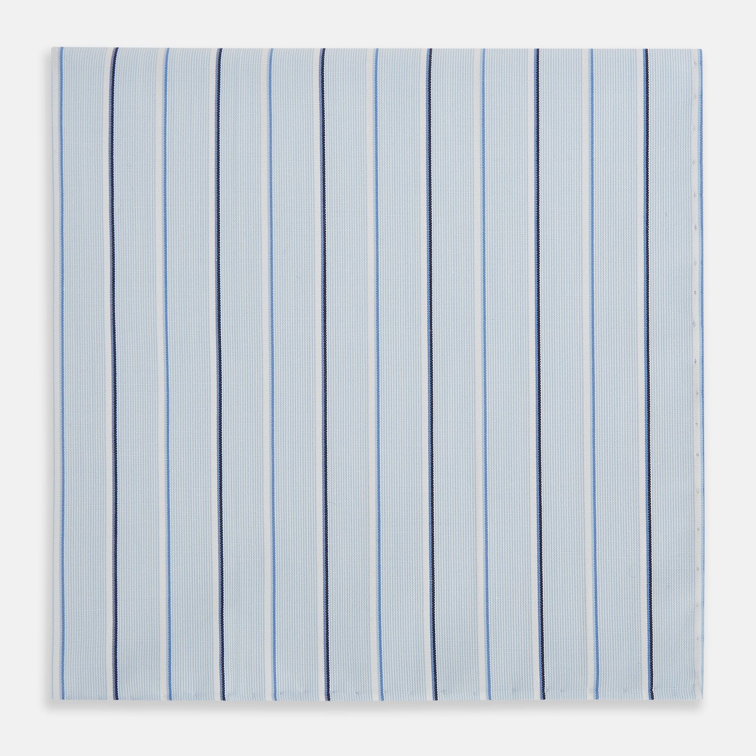 View 3 of product The Turnbull & Asser Navy and Blue Combination Stripe Hand-Rolled Handkerchief features a light blue base with evenly spaced dark blue pinstripes and refined hand-rolled edges, offering a classic, elegant look.
