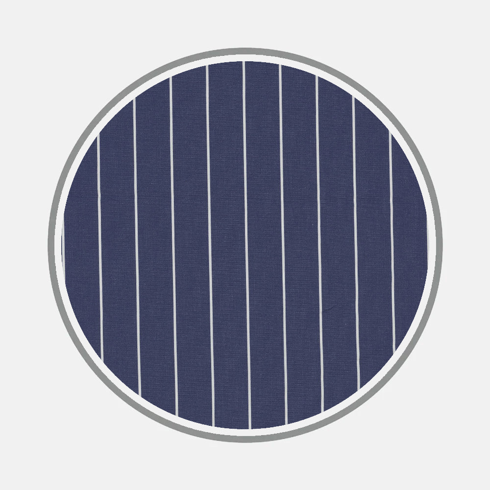 A circular navy blue design with evenly spaced vertical white lines and a thick gray border, set on light gray—evoking classic monogram styles from Turnbull & Asser's Bespoke Fabric 1087 05.