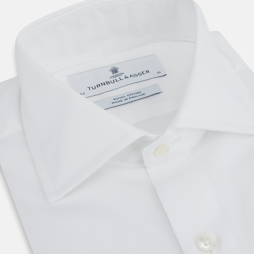 The Turnbull & Asser Tailored Fit White Royal Oxford Cotton Shirt features a Kent collar, double cuffs, and a crisp tailored design—perfect for classic style.