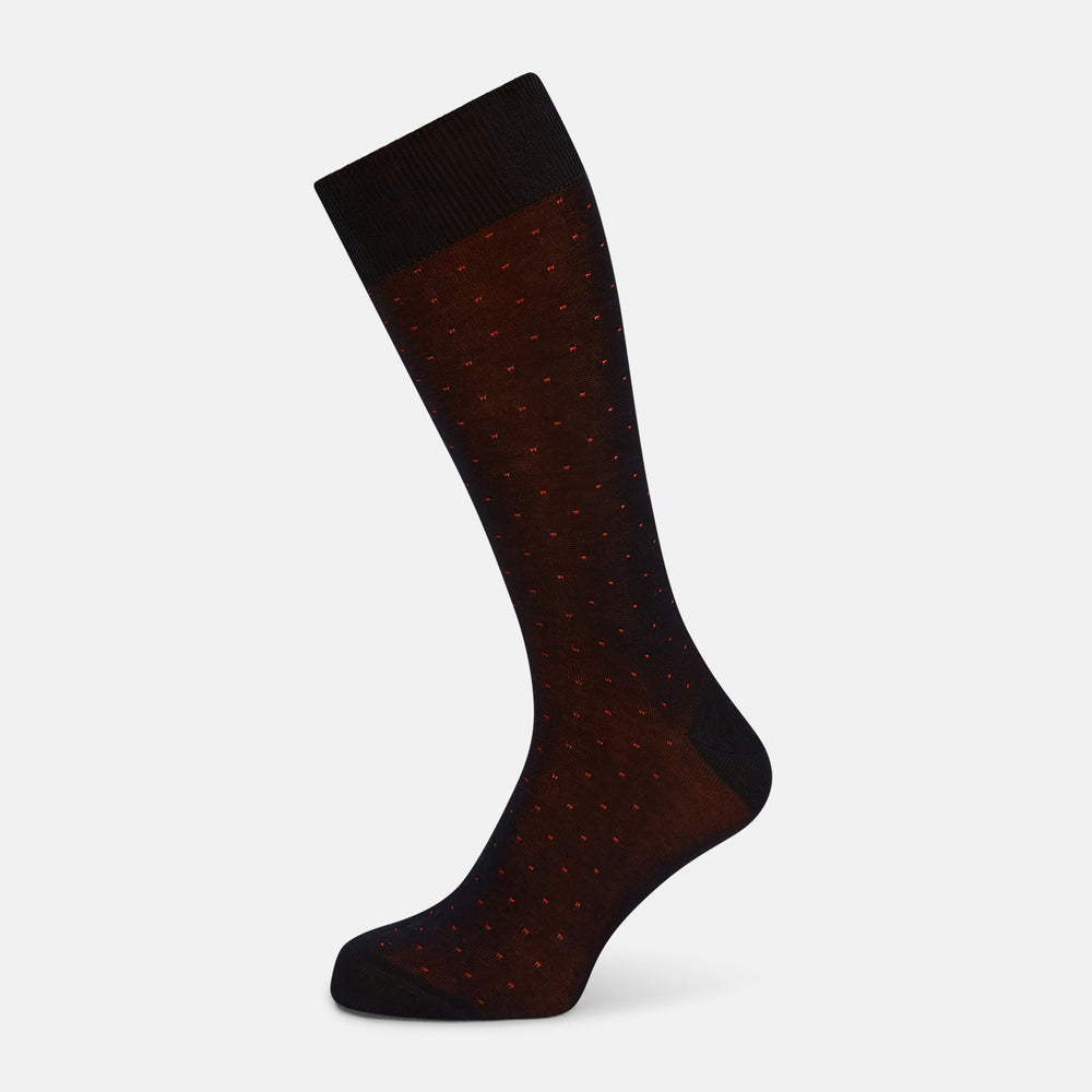 The Turnbull & Asser Navy/Red Polka Dot Mid-Length Sock is shown against a white background, featuring small red dots and solid black cuff, heel, and toe for classic style.