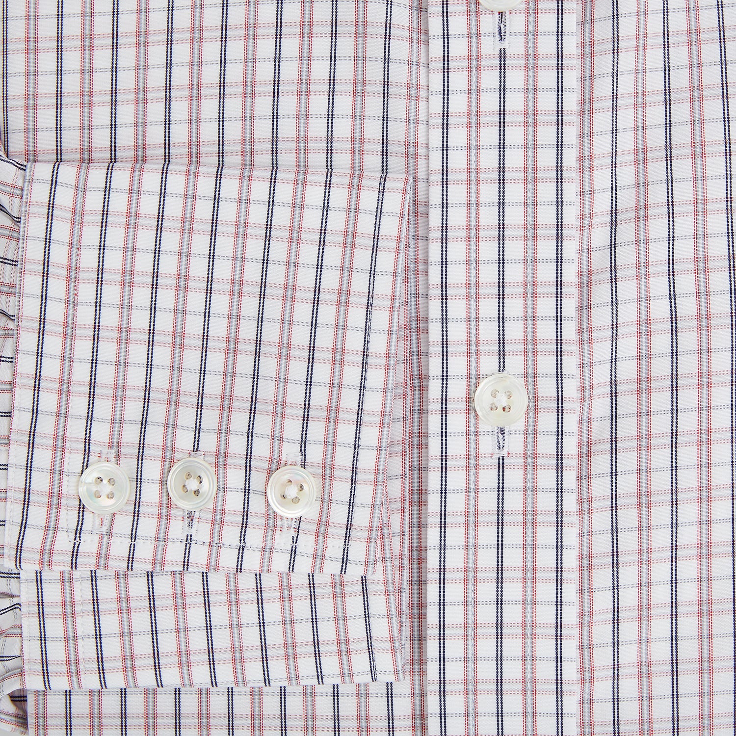 View 4 of product The Turnbull & Asser Red and Blue Multi Check Mayfair Shirt is a long-sleeve button-down made from Italian cotton with a white base and a light red and blue check pattern, shown laid flat on a white background.