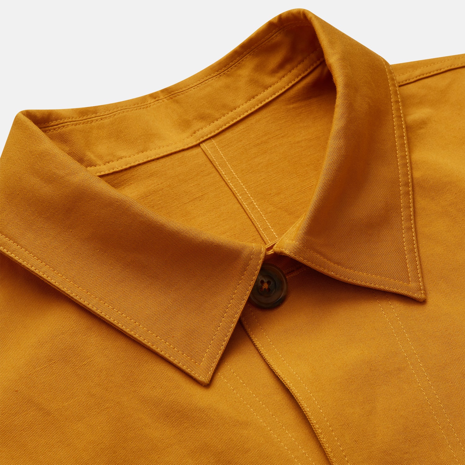 View 3 of product The Turnbull & Asser Ochre Cotton-Linen Remy Chore Jacket features a collar, long sleeves, brown front buttons, and three patch pockets, shown on a plain white background.