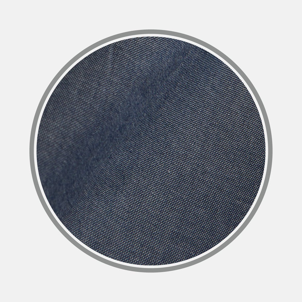 Close-up of BESPOKE FABRIC 1193 06 by Turnbull & Asser, showcasing dark blue denim's textured weave—ideal for bespoke or custom shirts—framed in a circular gray border on a white background.