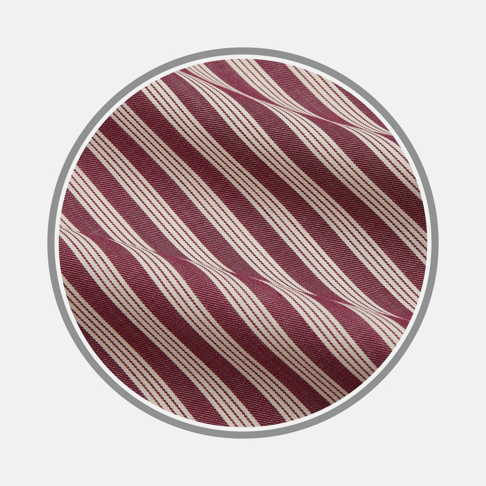 Close-up of BESPOKE FABRIC 1264 34 by Turnbull & Asser with diagonal maroon and white stripes, framed in a circle on a light background—ideal for custom shirts or trying monogram styles.