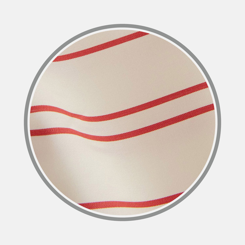 Close-up of cream-colored Turnbull & Asser NEW BESPOKE FABRIC 1276 08 with wavy red and orange stripes, perfect for custom shirts, shown inside a circular gray border on a white background.
