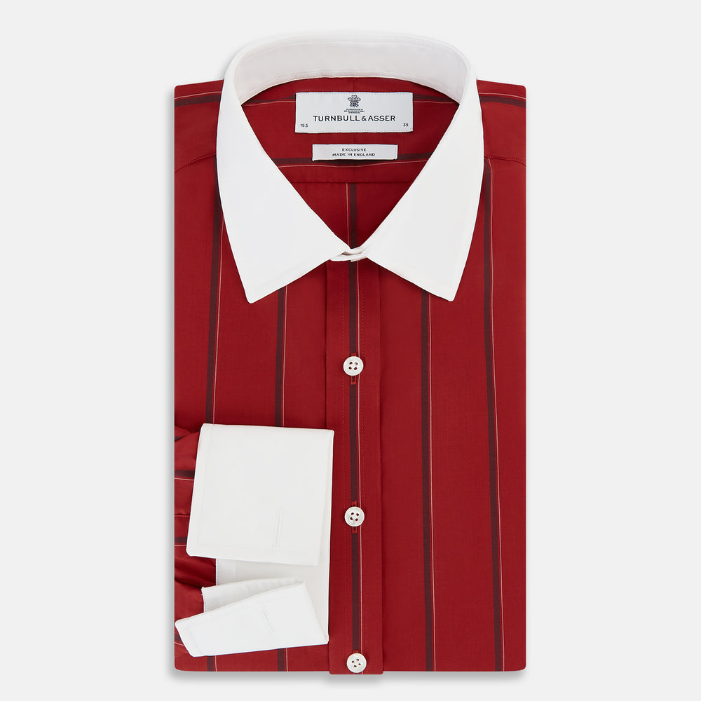 The Turnbull & Asser Dark Red Track Stripe Shirt with Contrast T&A Collar and Cuffs features vertical black stripes, a white collar and cuffs, Mayfair fit, and fine British craftsmanship, shown laid flat on a plain background.