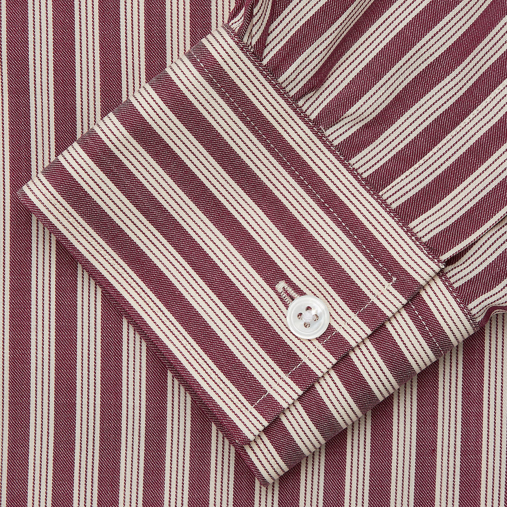 The Turnbull & Asser Burgundy Multi Stripe Weekend Fit Wool Shirt features a Derby collar, 1 button cuffs, and vertical red and white stripes, ideal for casual wear, shown against a white background.