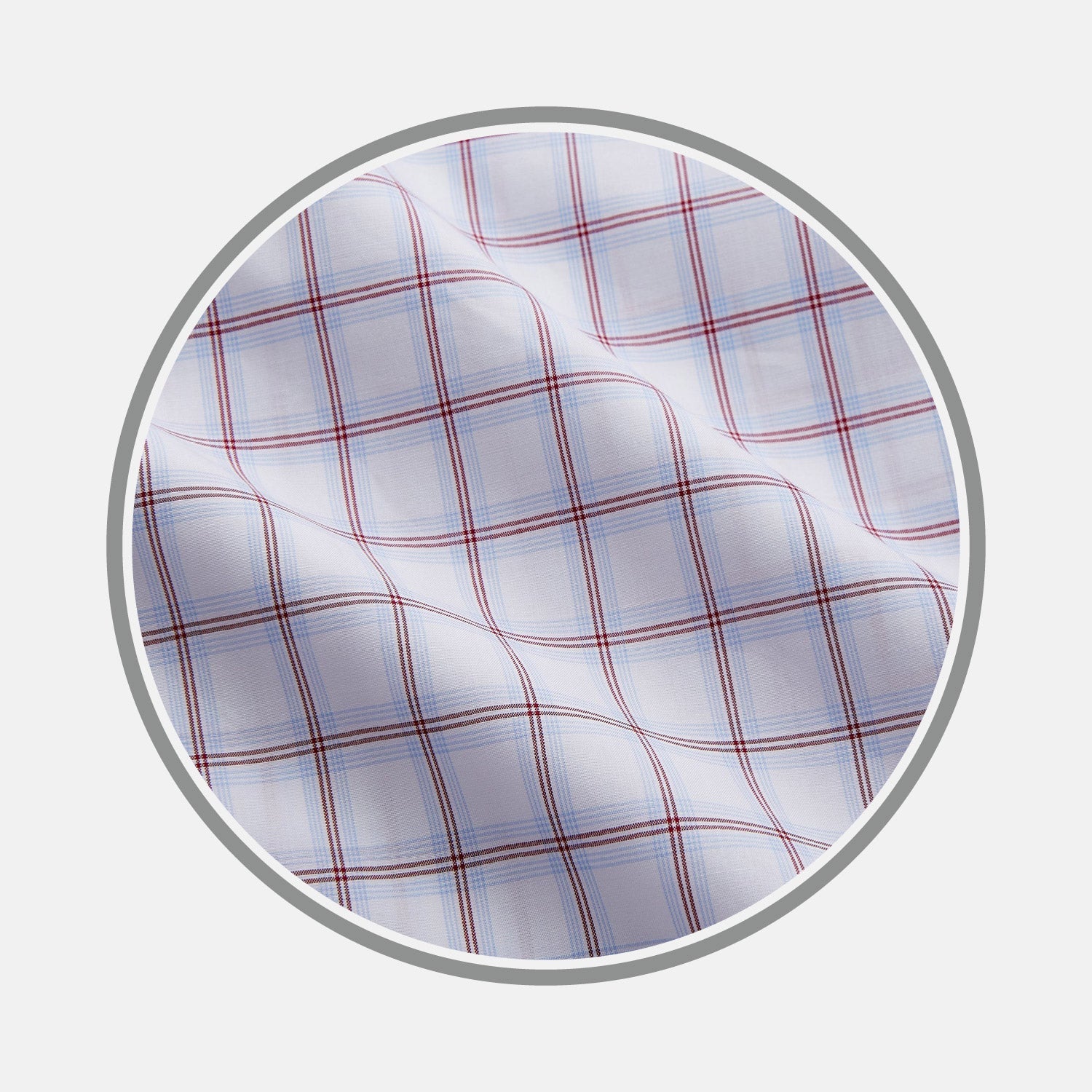 View 1 of product NEW BESPOKE FABRIC 1327 34 by Turnbull & Asser: White fabric with a red and blue plaid design, shown in a circular frame. Perfect for bespoke or custom shirts, the material features intersecting lines forming squares and a slightly wrinkled texture.