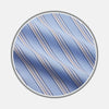 View 1 of product Close-up of Turnbull & Asser’s NEW BESPOKE FABRIC 1330 33: light blue fabric with wavy white, navy, and tan diagonal stripes, ideal for custom shirts, displayed in a circular frame on a plain gray background.