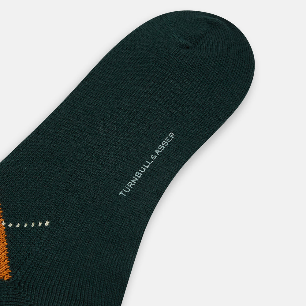 The Forest Green Wool Check Mid-Length Socks by Turnbull & Asser feature a dark green base with orange and brown argyle checks and white dotted lines, shown against a plain white background.