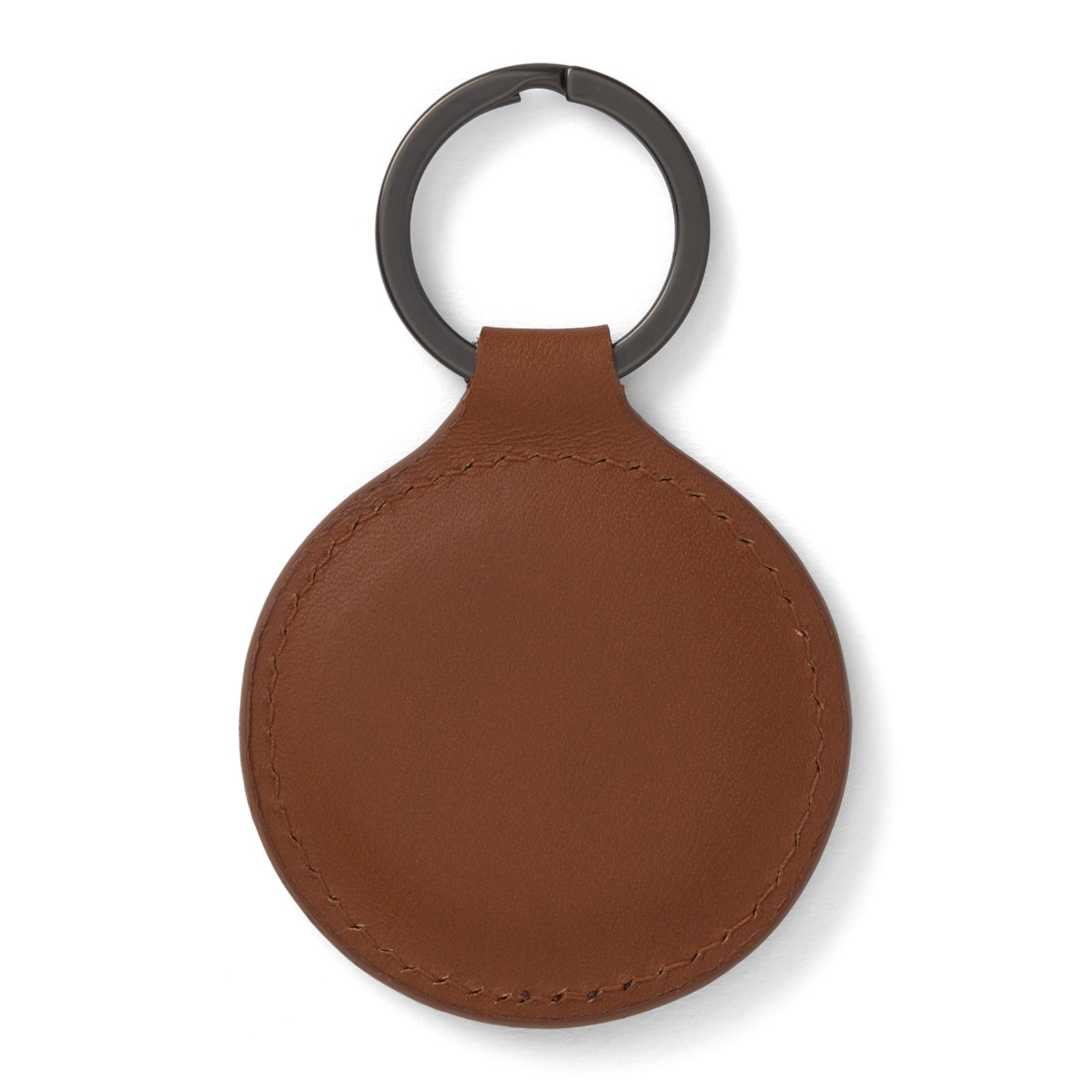View 2 of product A tan circular leather fob holder by Turnbull & Asser, featuring visible stitching, embossed branding, and 'Made in England,' attached to a metal key ring.