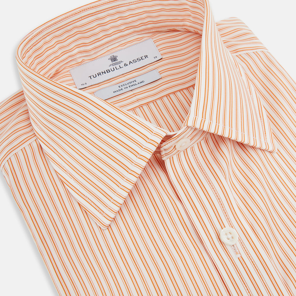 The Turnbull & Asser Orange Ticking Stripe Mayfair Shirt features thin vertical stripes, a classic T&A collar, and buttoned cuffs, shown on a plain white background.