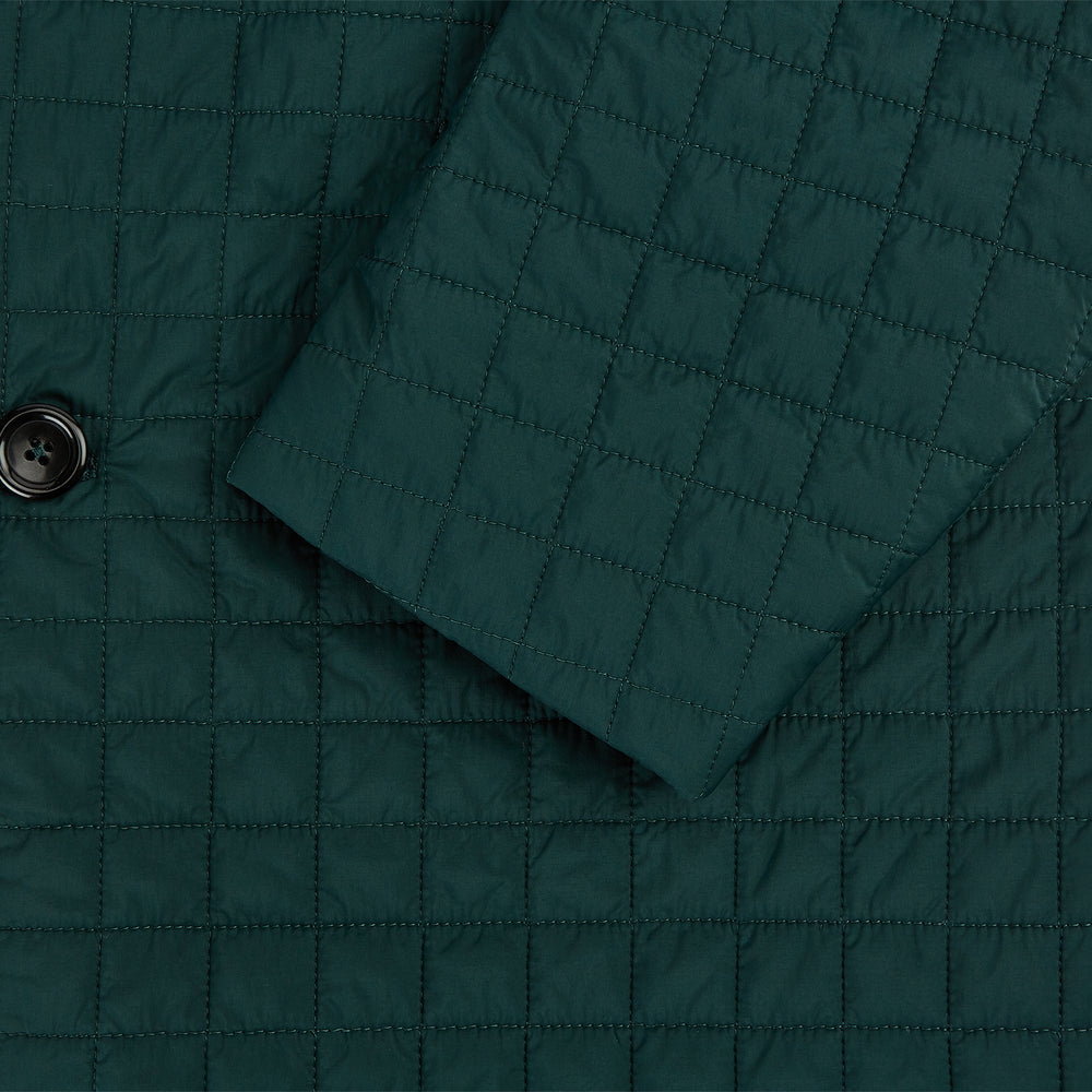 The Turnbull & Asser Fulham Forest Green Single-Breasted Quilted Blazer features a three-button front, notched lapels, chest pocket, and two front flap pockets—an elegant choice for the modern gentleman on a plain white background.