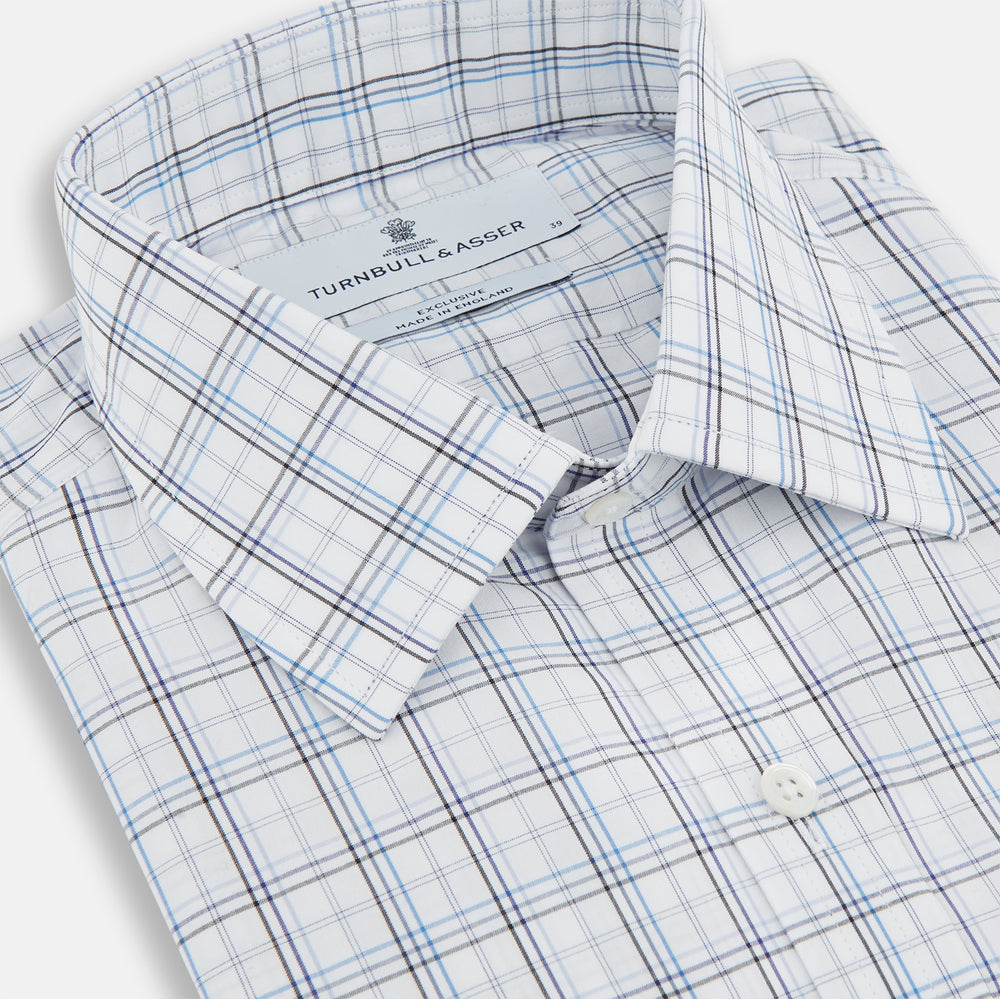 The Turnbull & Asser Purple and Blue Multi Check Mayfair Shirt features long sleeves, a button-up front, and a classic T&A collar, with blue and light gray checks on white, displayed flat against a plain white background.