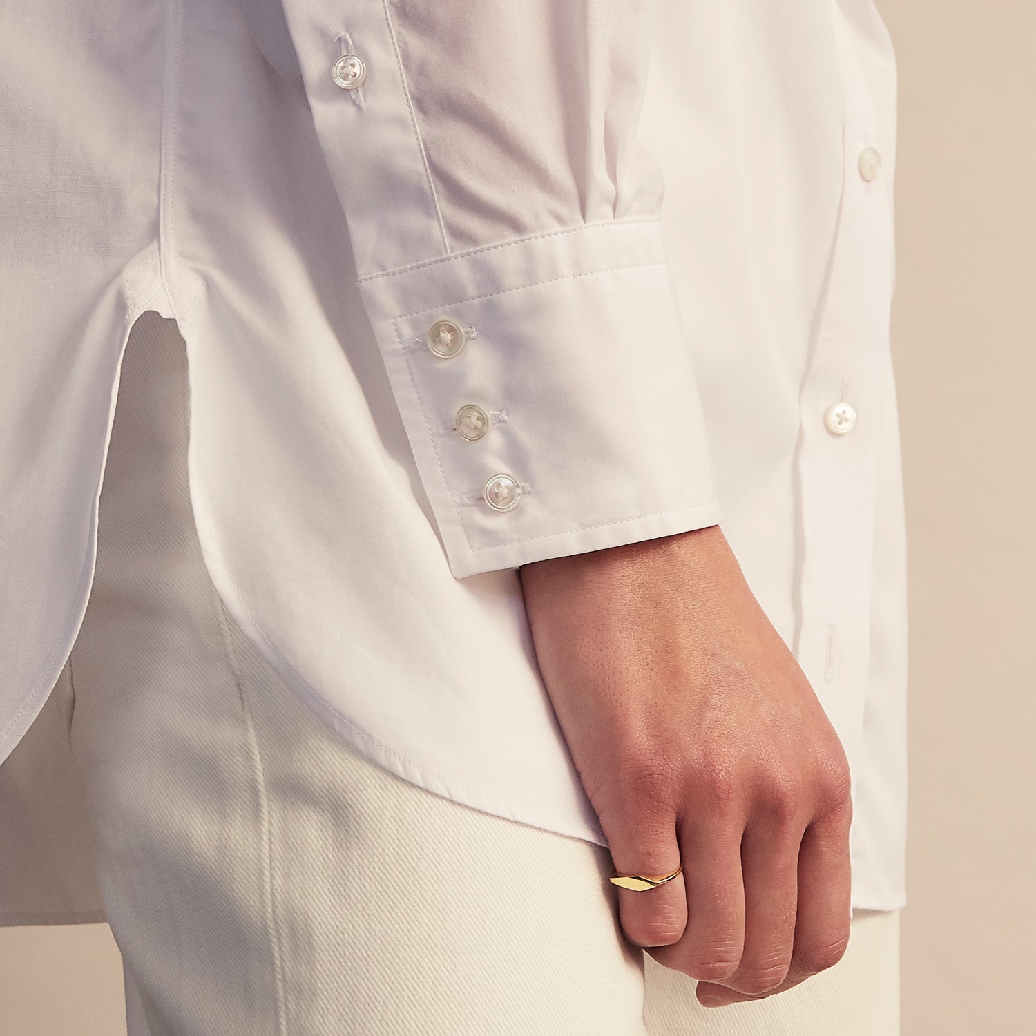 View 7 of product The White Cotton Lauren Shirt by Turnbull & Asser, featuring a stand collar, button-down front, and elongated body, is laid flat on a plain white background.