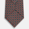 View 3 of product The Turnbull & Asser Red and Navy Weave-Patterned Printed Silk Tie features an intricate geometric design in red, blue, and white. Displayed rolled-up against a plain white background, this classic tie is crafted from luxurious silk.