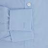 View 4 of product The Turnbull & Asser Blue Cotton Shirt features a T&A collar, double cuffs, and white buttons. This classic formal shirt is perfect for any gentleman and pairs effortlessly with a navy suit. Displayed on a plain white background.