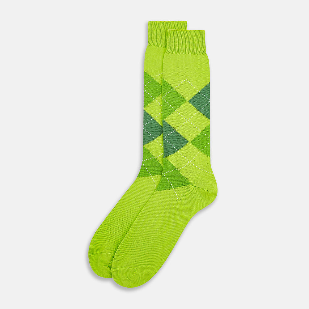 The Lime Check Mid-Length Sock by Turnbull & Asser features a green and yellow argyle pattern with a ribbed cuff, crafted from comfortable cotton material, and is shown on a plain light background.