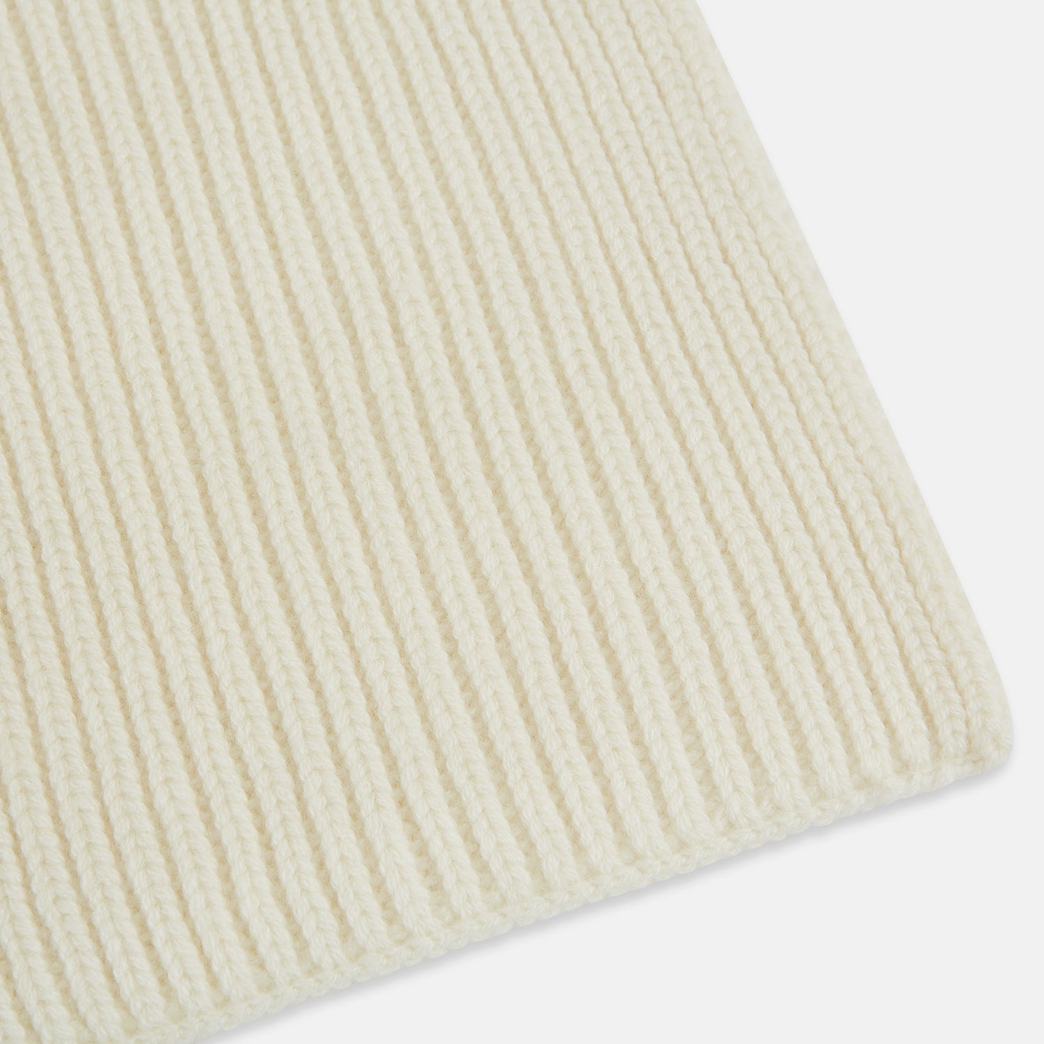 Image 2 of product The Turnbull & Asser Ivory Rib-Knit Cashmere Scarf is tied in a simple loop, showing off its textured finish against a plain white background.