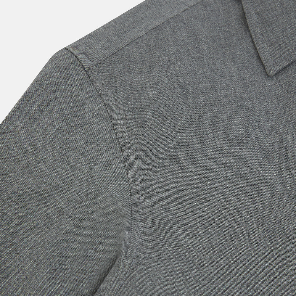 The Pale Charcoal Westminster Shirt by Turnbull & Asser features British craftsmanship with a tailored silhouette, long sleeves, pointed collar, buttoned cuffs, and a solid pale charcoal hue, elegantly shown against a white background.