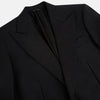 View 10 of product The Turnbull & Asser Black Single Breasted Dinner Suit, with satin lapels and matching trousers, is elegantly folded and displayed on a plain white background.