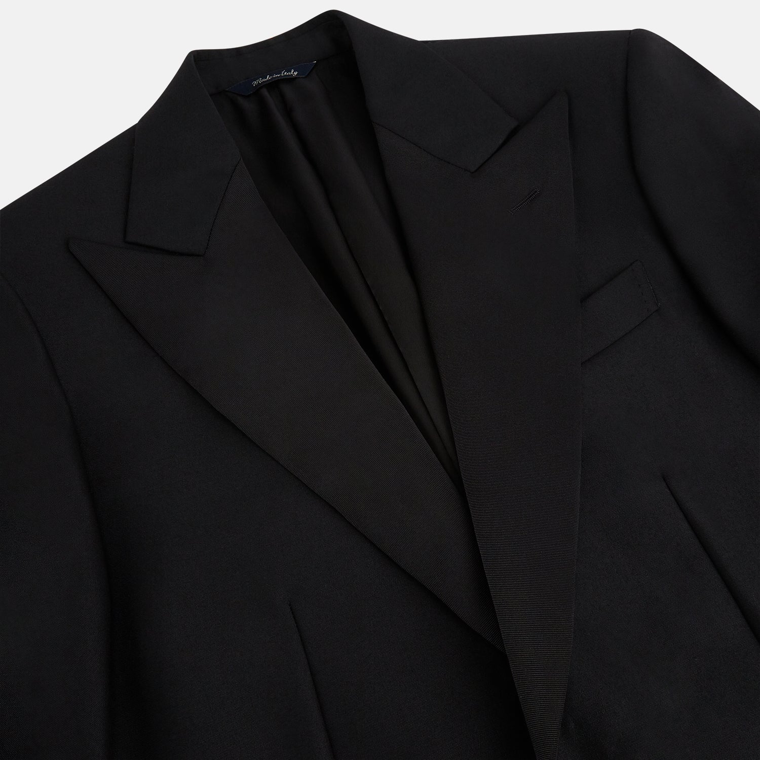 View 10 of product The Turnbull & Asser Black Single Breasted Dinner Suit, with satin lapels and matching trousers, is elegantly folded and displayed on a plain white background.