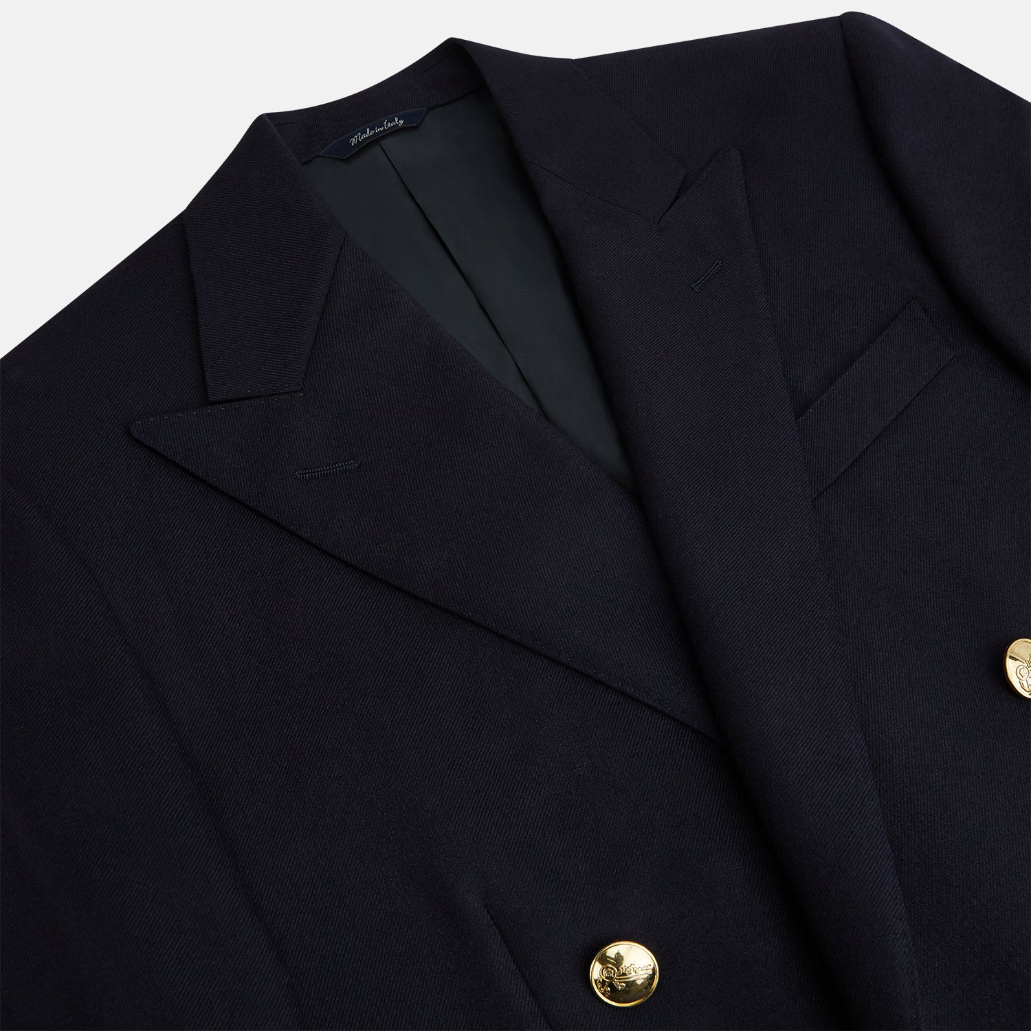 View 2 of product The Turnbull & Asser Short Navy Double Breasted Classic Blazer, featuring gold buttons, peaked lapels, and two front flap pockets, is displayed on a plain white background.