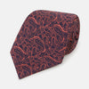 View 1 of product The Turnbull & Asser Orange Paisley Silk Tie, crafted from fine English silk, features an elegant paisley pattern and is stylishly rolled up on a plain white background.
