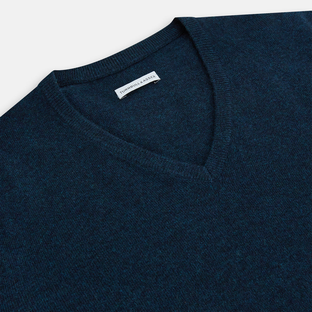 The Turnbull & Asser Dark Green Melange Cashmere V-neck Jumper features long sleeves, ribbed cuffs and hem—an essential piece of classic knitwear displayed on a white background.