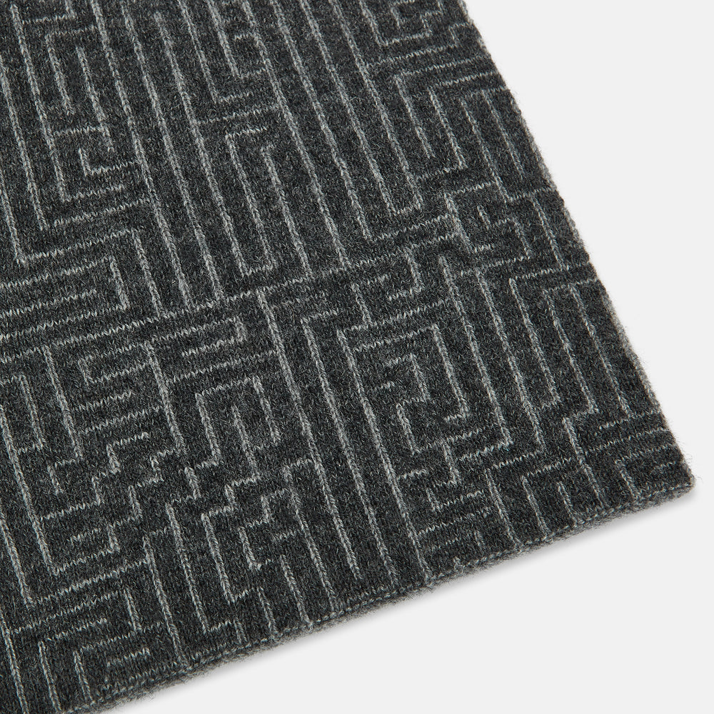 The Turnbull & Asser Grey Fretwork Cashmere Knitted Scarf showcases a geometric maze-like pattern in gray, elegantly looped with draped ends—an essential accessory set against a plain white background.