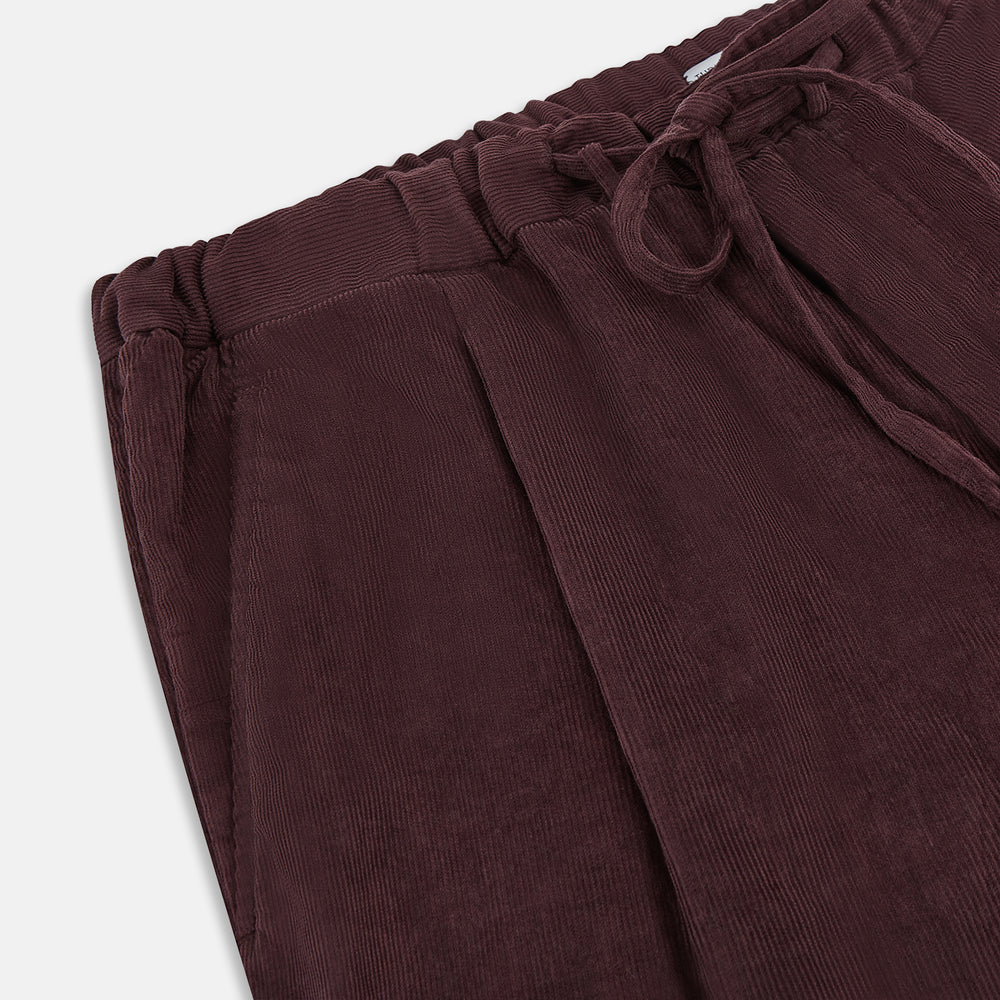Turnbull & Asser Burgundy Corduroy Miles Trousers: high-waisted, straight-leg pants with an elasticated drawstring waist, shown on a white background.