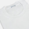 View 2 of product Experience comfort in the Turnbull & Asser White Short-sleeve Pyjama Shirt—a plain crew neck T-shirt laid flat on a white background, perfect as elevated loungewear or a sleek pyjama essential.
