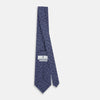 View 4 of product The Turnbull & Asser Navy Paisley Printed Silk Tie, featuring an intricate light lavender paisley design, is shown rolled up on a plain white background.