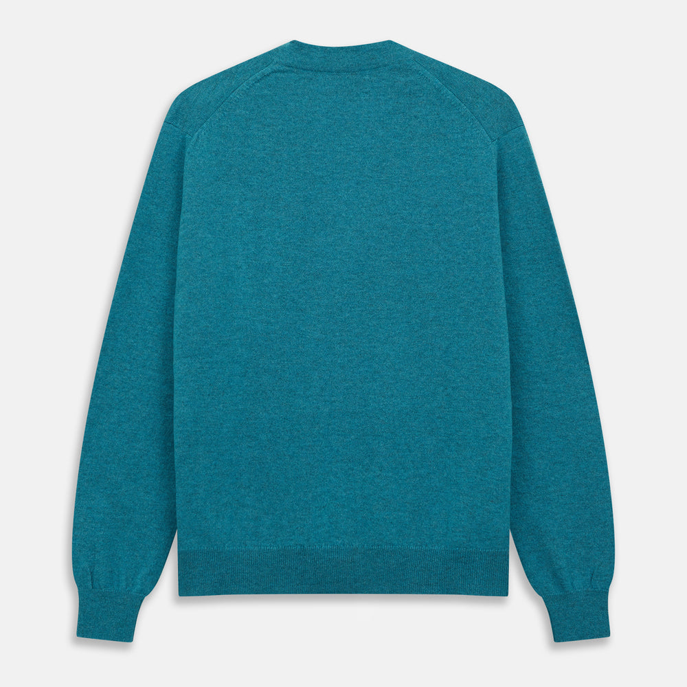The Teal Lachlan Cashmere Cardigan by Turnbull & Asser features long sleeves, front pockets, and ribbed hem and cuffs. Displayed flat on a white background, this cozy piece is inspired by classic Scottish knitwear.