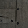 View 4 of product The Olive Linen Holland Shacket by Turnbull & Asser is a lightweight olive button-up jacket in Irish linen with a collar, two front pockets, one chest pocket, and slanted hem pockets—ideal outerwear shown on a plain white background.