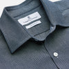 View 2 of product The Turnbull & Asser Blue Weekend Fit Oxford Finch Shirt features a Derby collar, chest pocket, white buttons, and classic fit—part of the Weekend Fit shirts collection—laid flat on a white background.