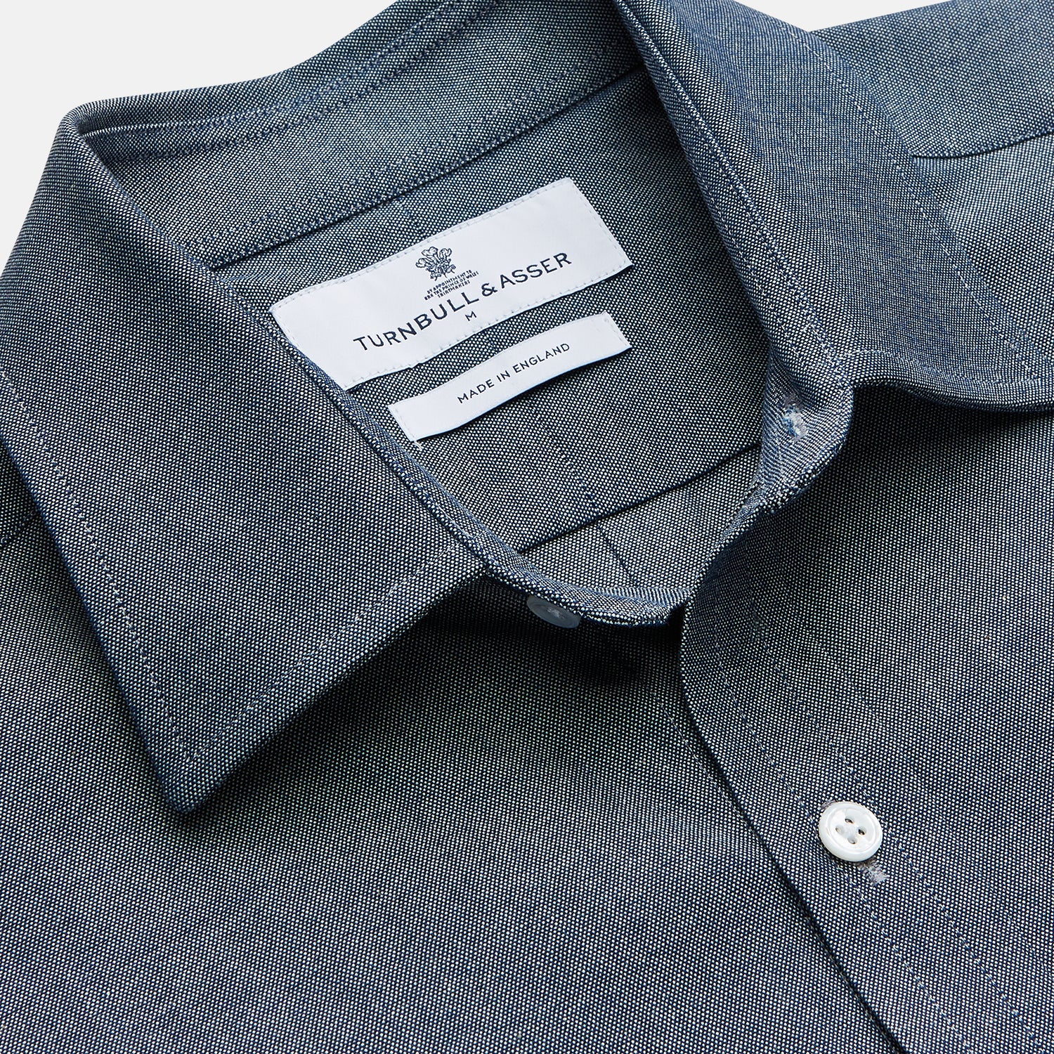 View 2 of product The Turnbull & Asser Blue Weekend Fit Oxford Finch Shirt features a Derby collar, chest pocket, white buttons, and classic fit—part of the Weekend Fit shirts collection—laid flat on a white background.