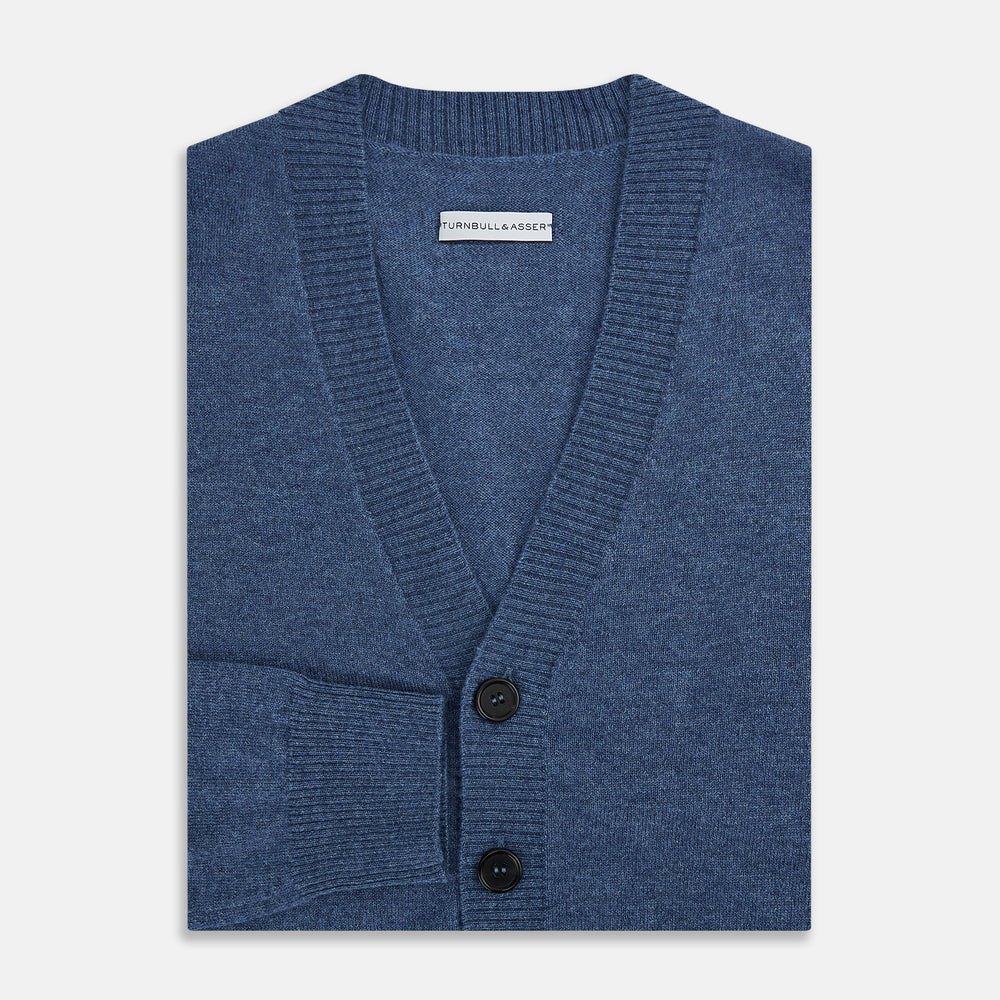 Turnbull & Asser Blue Cashmere Cardigan in soft knit, with black buttons, ribbed cuffs and hem, and two front pockets in vibrant colours—shown on a plain white background.
