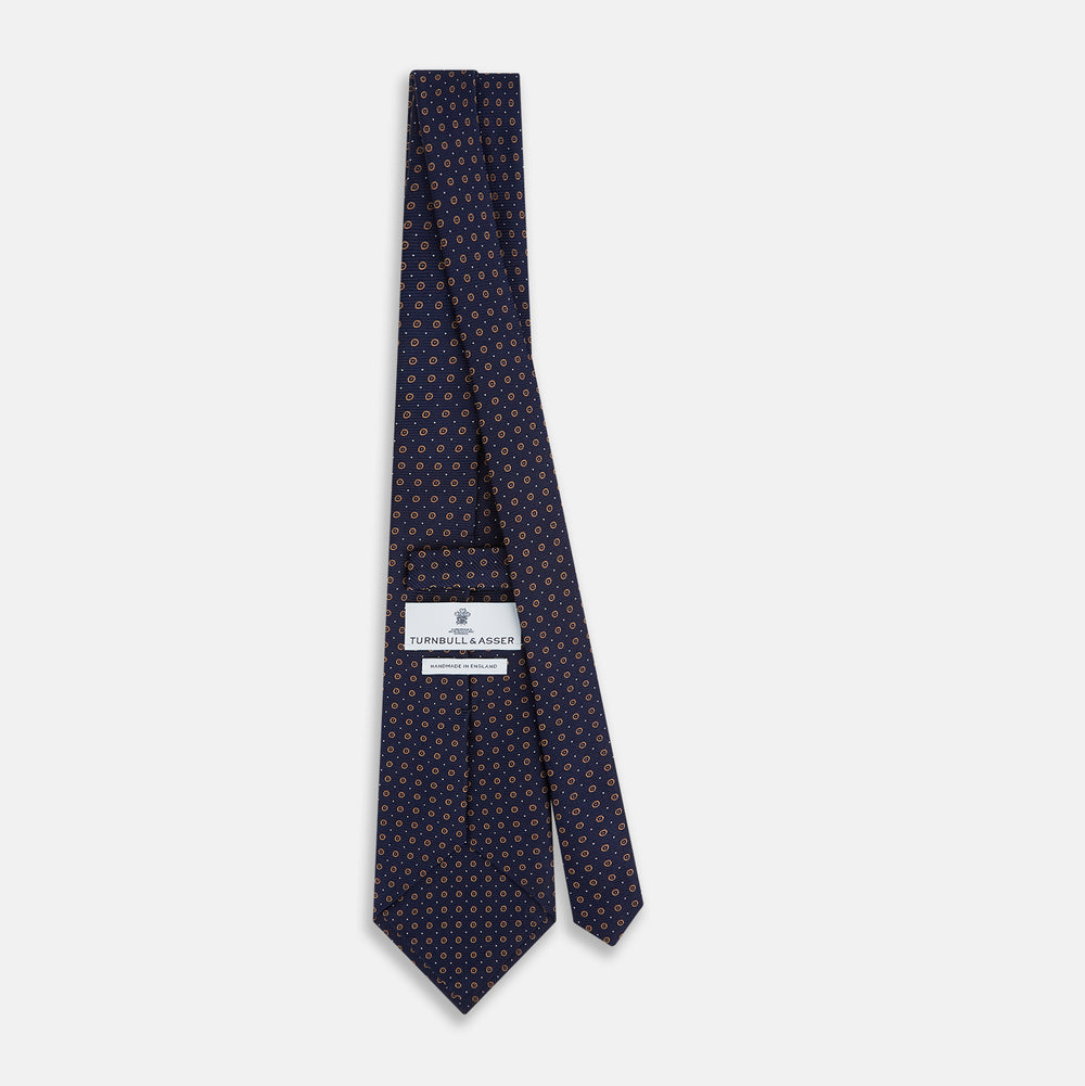 The Turnbull & Asser Navy and Brown Circle Silk Tie features an elegant pattern, perfect for adding a refined touch to your modern office attire.