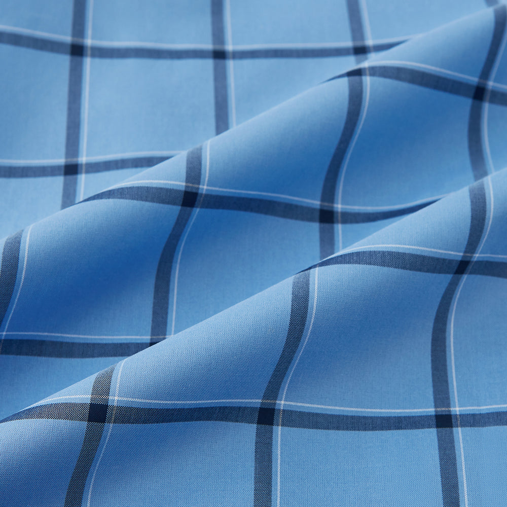 The Turnbull & Asser Colony Blue Grid Check Mayfair Shirt is a light blue, long-sleeve button-up with a collar and evenly spaced dark blue grid lines.