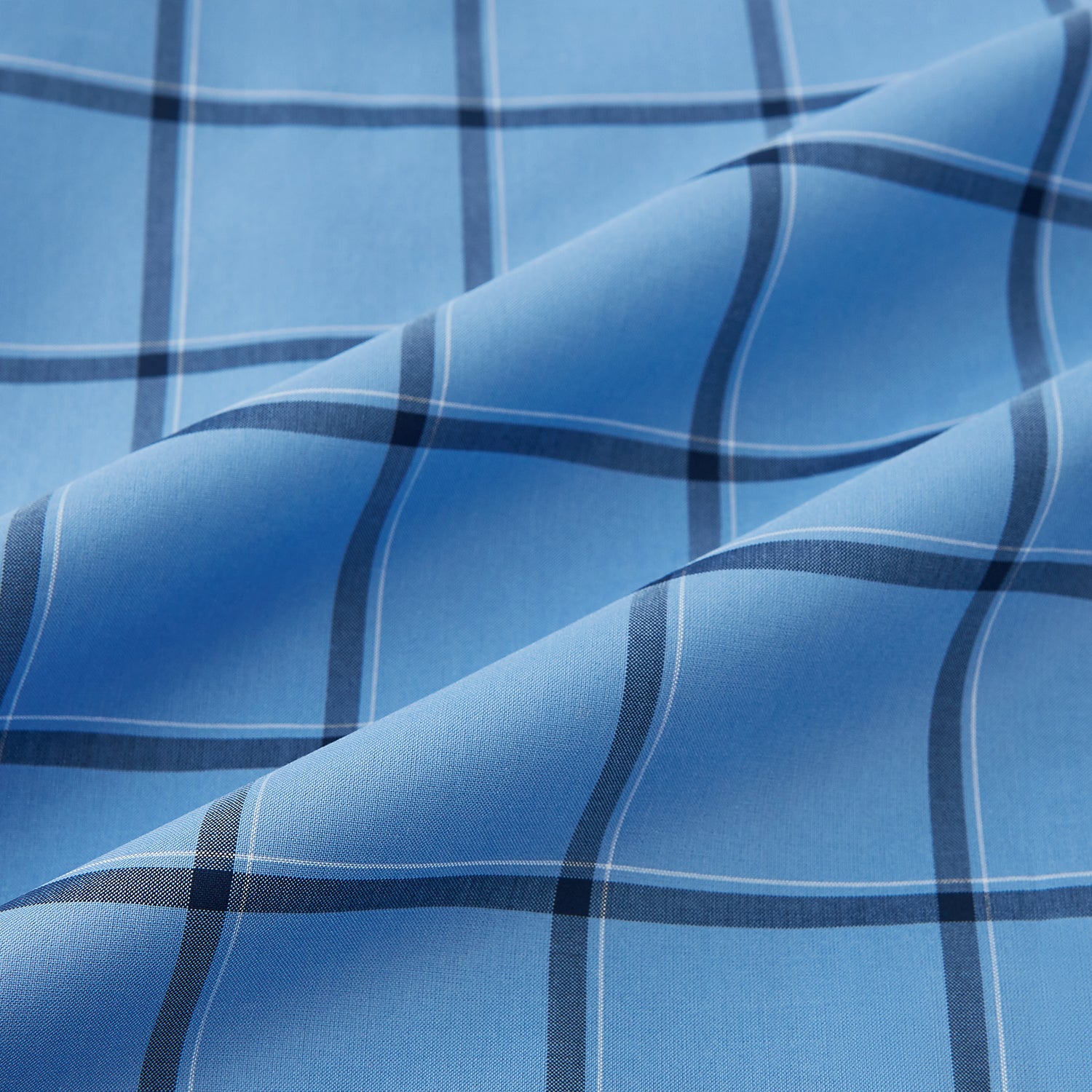 View 6 of product The Turnbull & Asser Colony Blue Grid Check Mayfair Shirt is a light blue, long-sleeve button-up with a collar and evenly spaced dark blue grid lines.