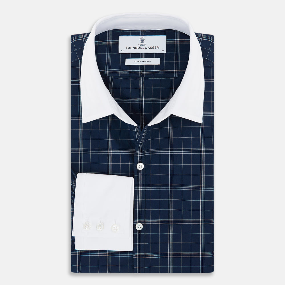 The Turnbull & Asser Indigo Windowpane Check Windsor Shirt features a contrast T&A collar and cuffs, highlighting British craftsmanship. It is displayed flat on a white background.